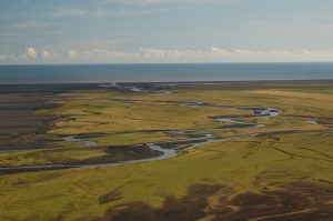 Meandrující řeka Skógá před ústím do Atlantského oceánu, vzdušnou čarou cca 14 km od sopky Eyjafjallajökull (červenec 2010).
